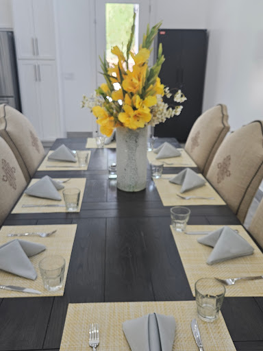 A beautifully arranged dining table with elegant dcor and fresh flowers.