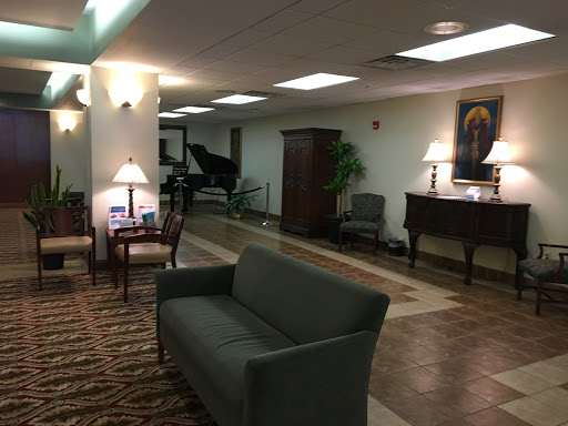 A serene lobby area featuring comfortable seating and a piano, ideal for relaxation.