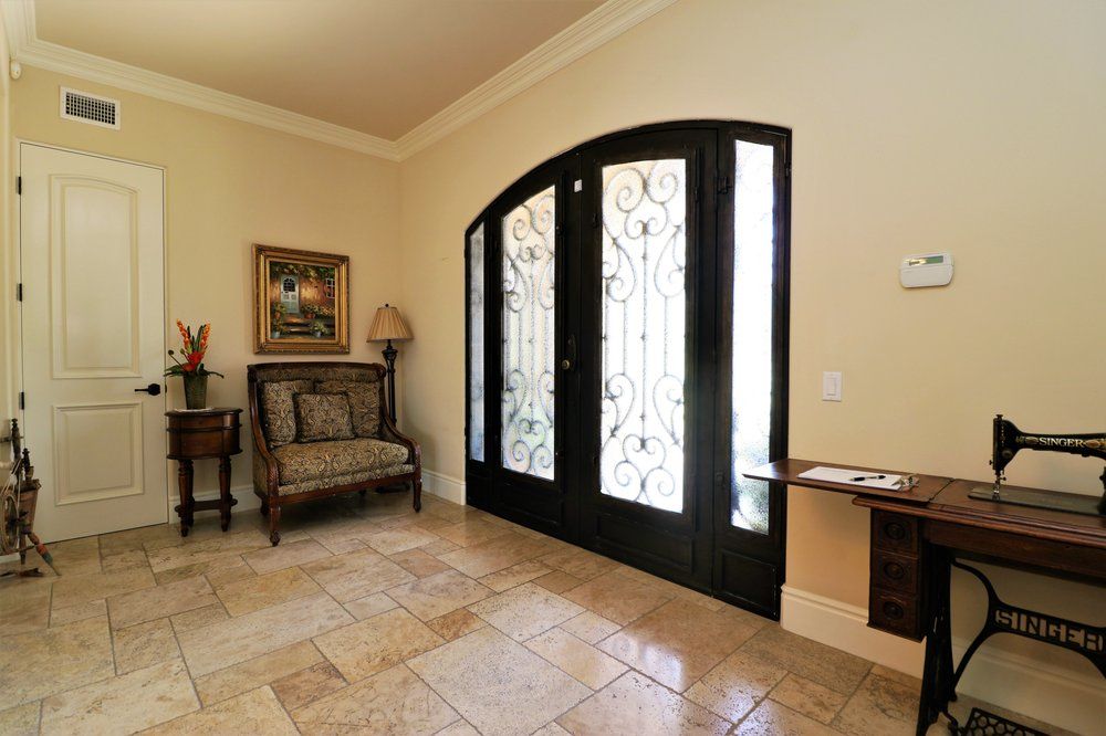 A beautifully decorated entryway with elegant doors and tasteful furnishings.