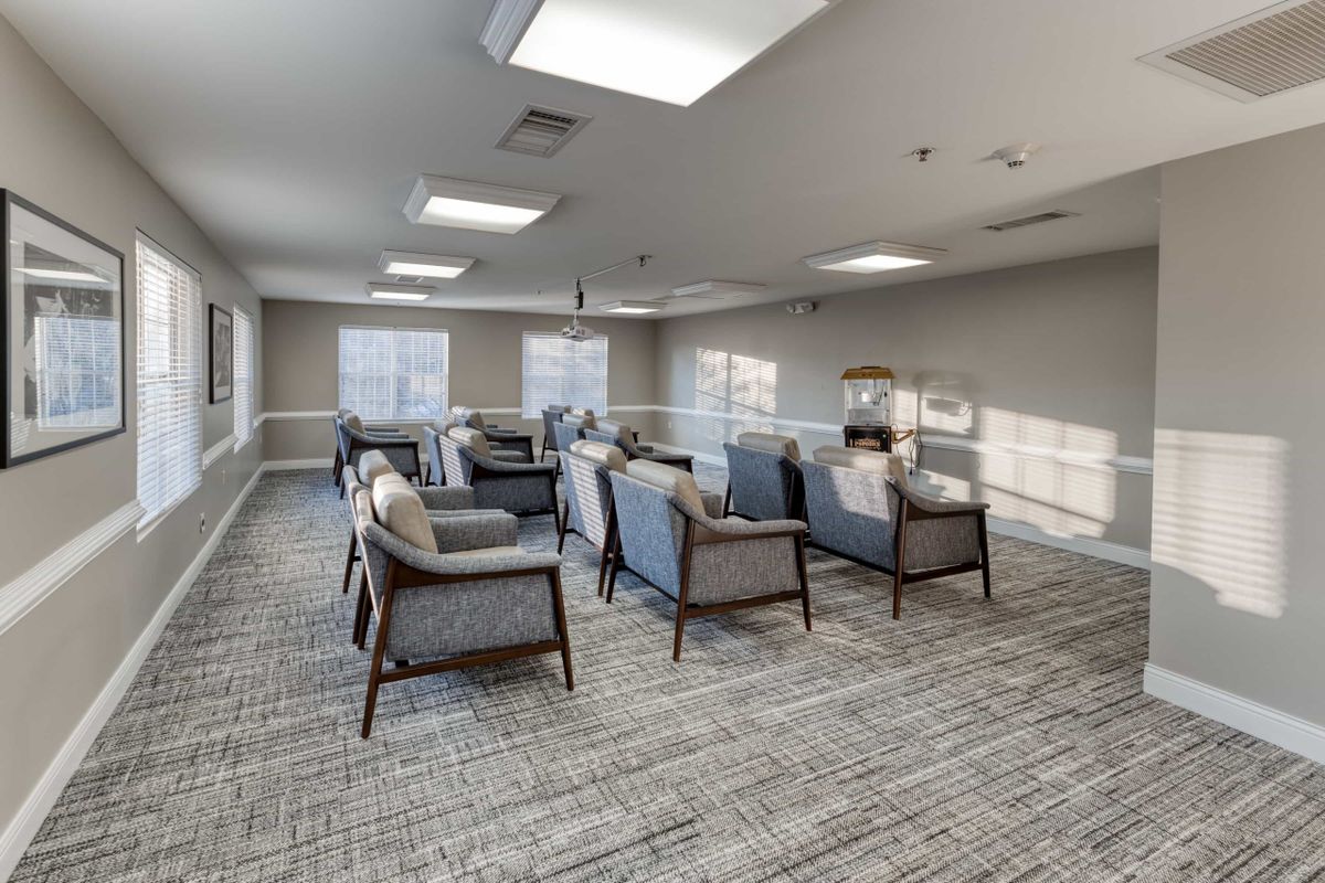 A modern meeting room with comfortable seating and ample natural light.
