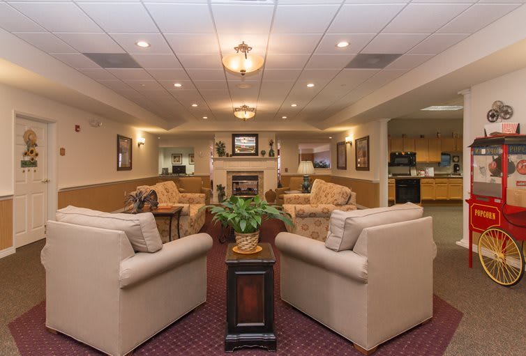 A cozy lobby with comfortable sofas and a fireplace in a warmly lit interior.