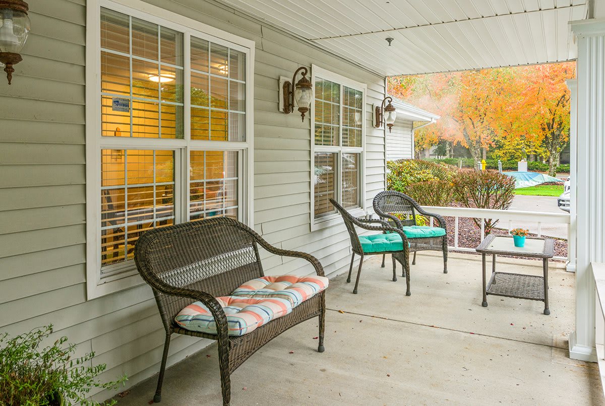 A cozy front porch with comfortable seating and decorative cushions.
