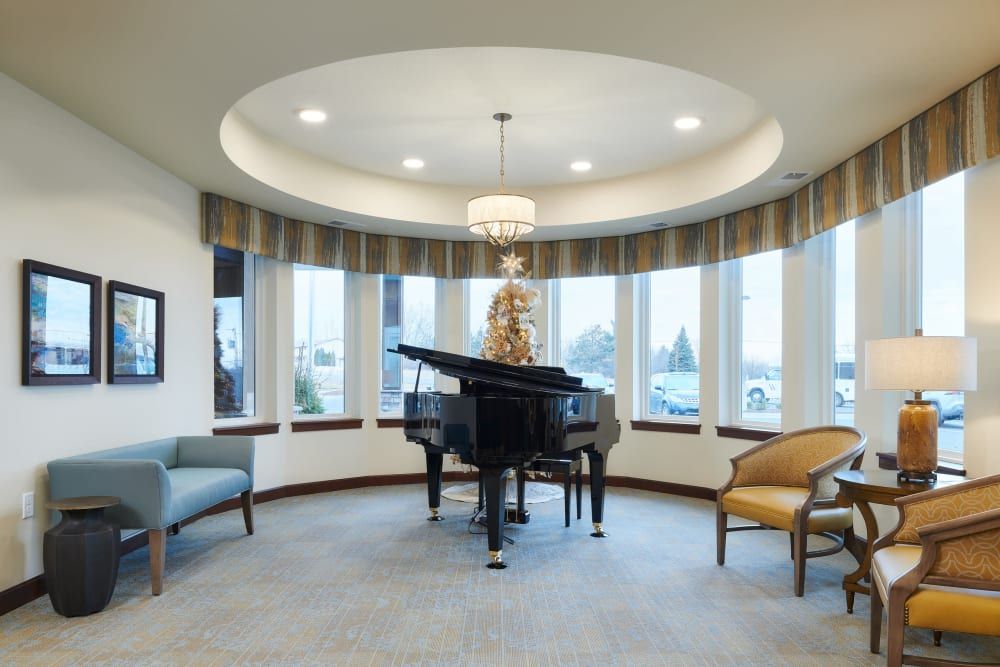 A beautifully designed living room featuring a grand piano and elegant seating arrangement.