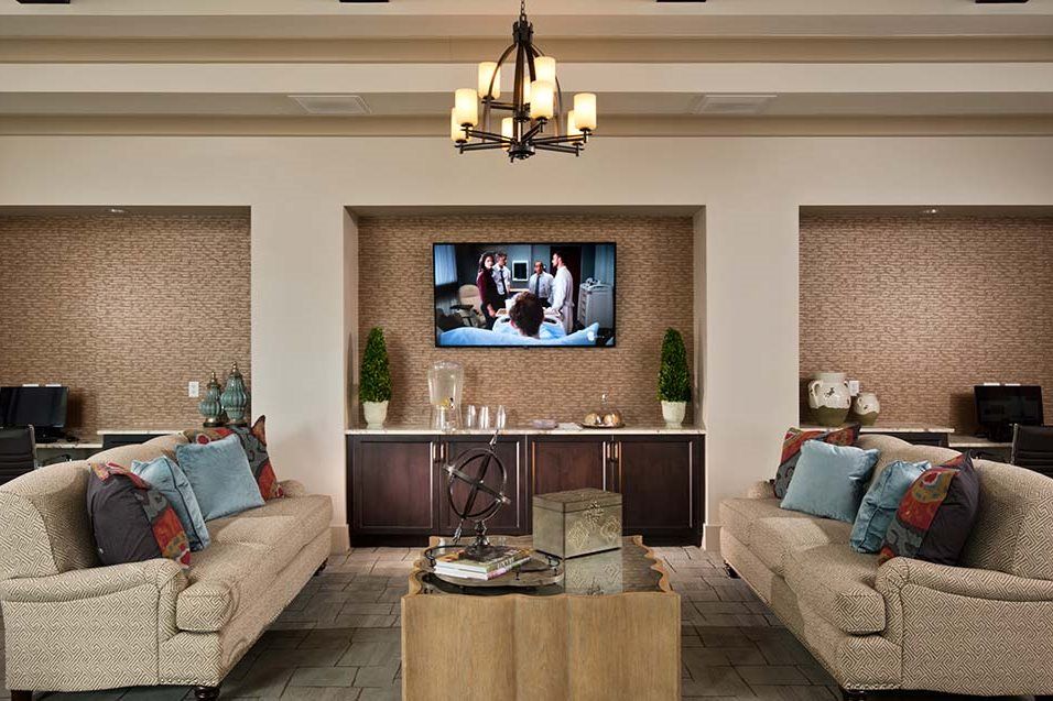 A stylishly designed living room with modern furniture and a wall-mounted television.