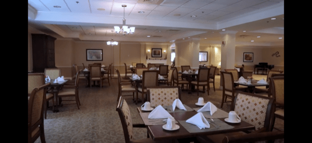 An elegantly set dining area with neatly arranged tables and chairs.
