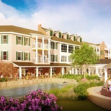 A picturesque building with a landscaped garden and people enjoying the outdoor space.