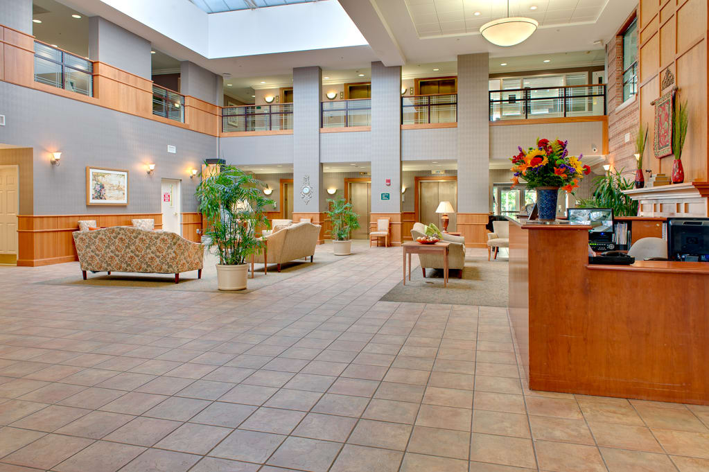 A modern and spacious lobby with a reception desk and comfortable seating area.