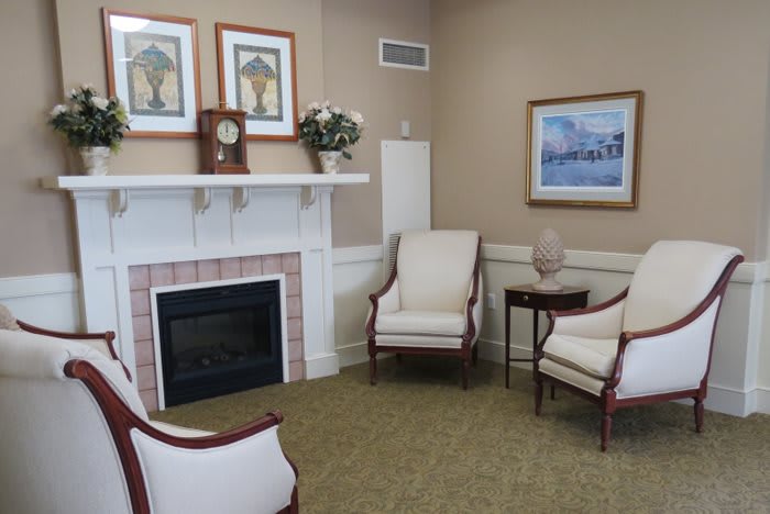 A cozy living room with a fireplace and comfortable seating.