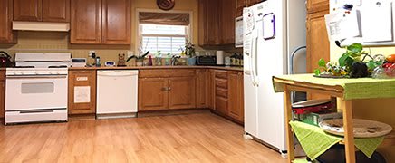 A cozy kitchen with wooden cabinets and modern appliances.