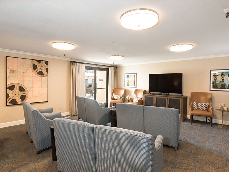 A modern living room with comfortable seating and a large television.