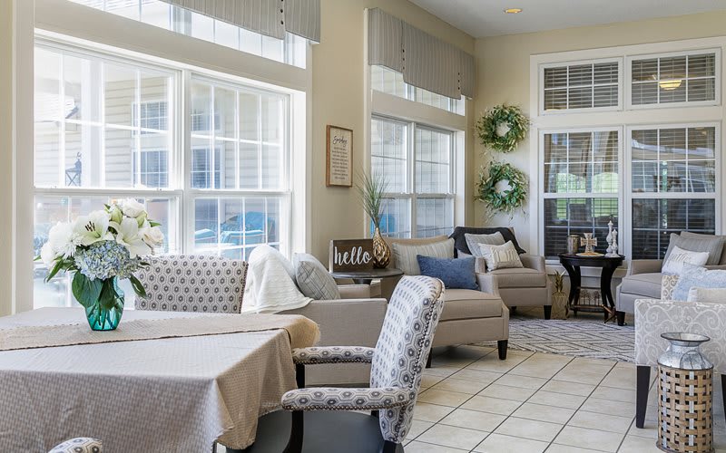 Bright and cozy living room with comfortable seating and large windows.