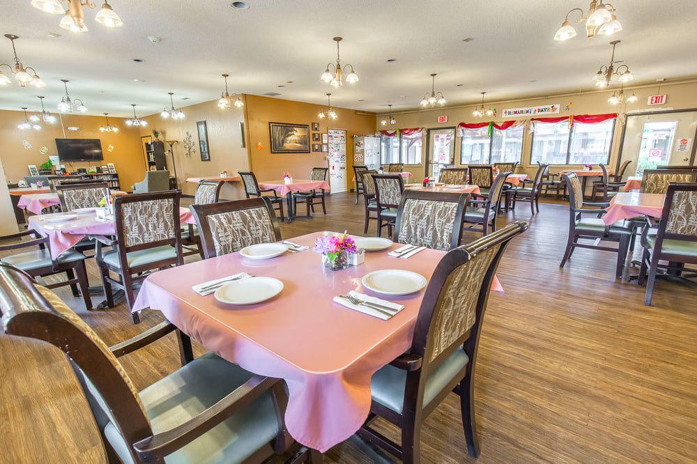 An empty dining room with neatly set tables and chairs, ready for guests.