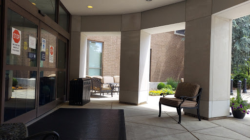 A serene lobby area leading to a cozy courtyard with seating.