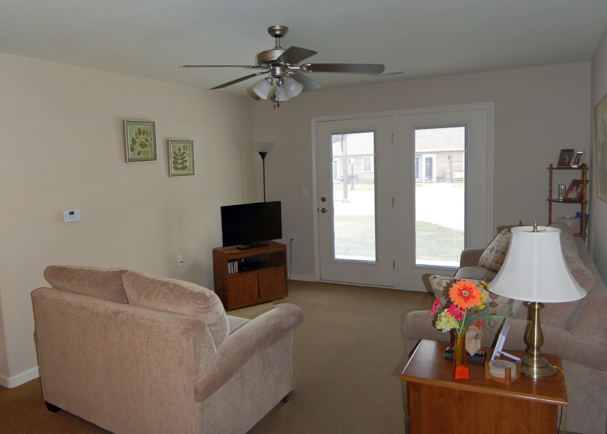 A cozy living room with a sofa, TV, and decorative elements.