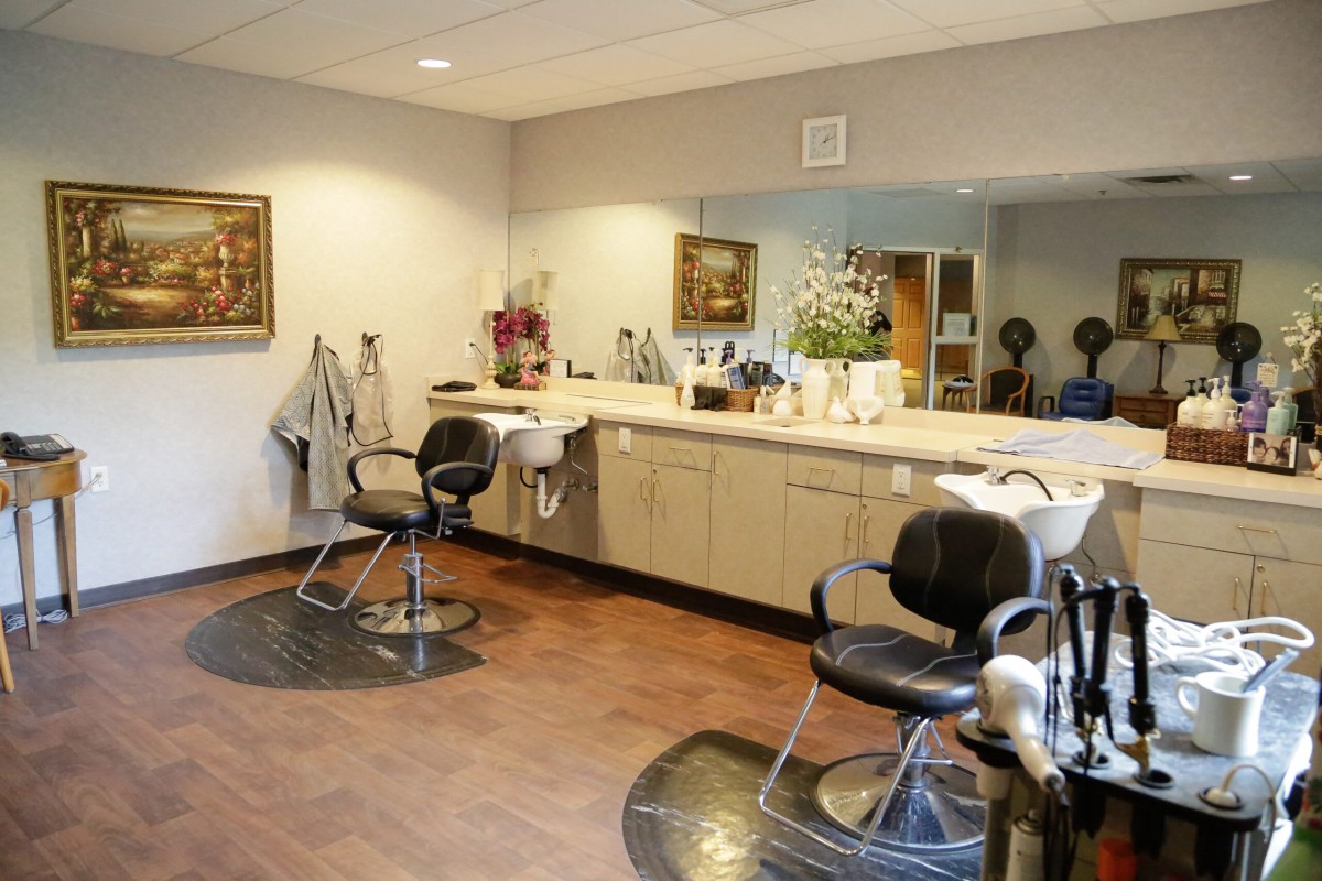A clean and well-organized hair salon with styling chairs, mirrors, and various beauty tools.