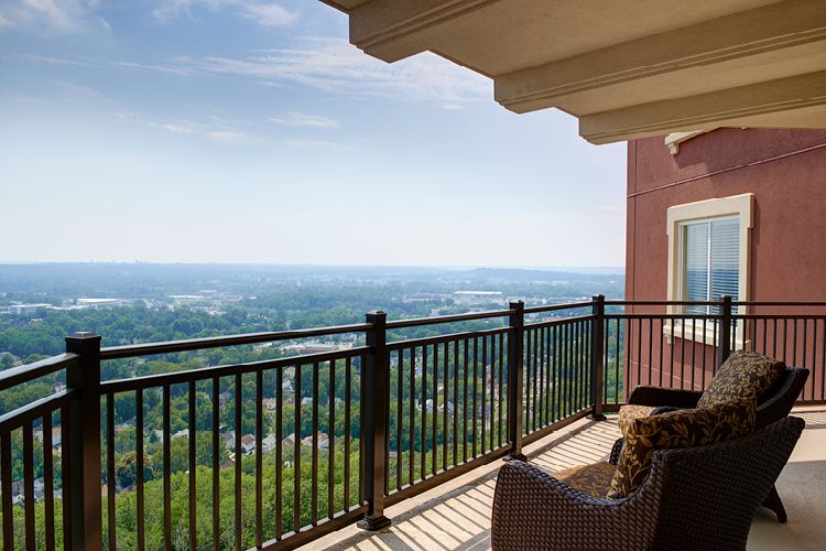 A peaceful balcony overlooking a scenic landscape.