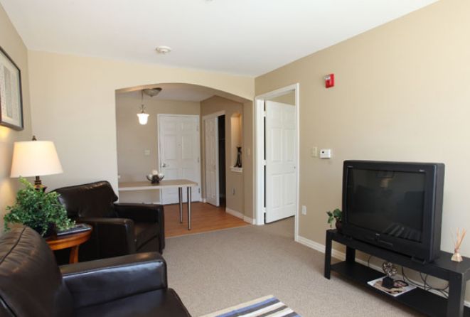 A modern living room with comfortable seating and a television.