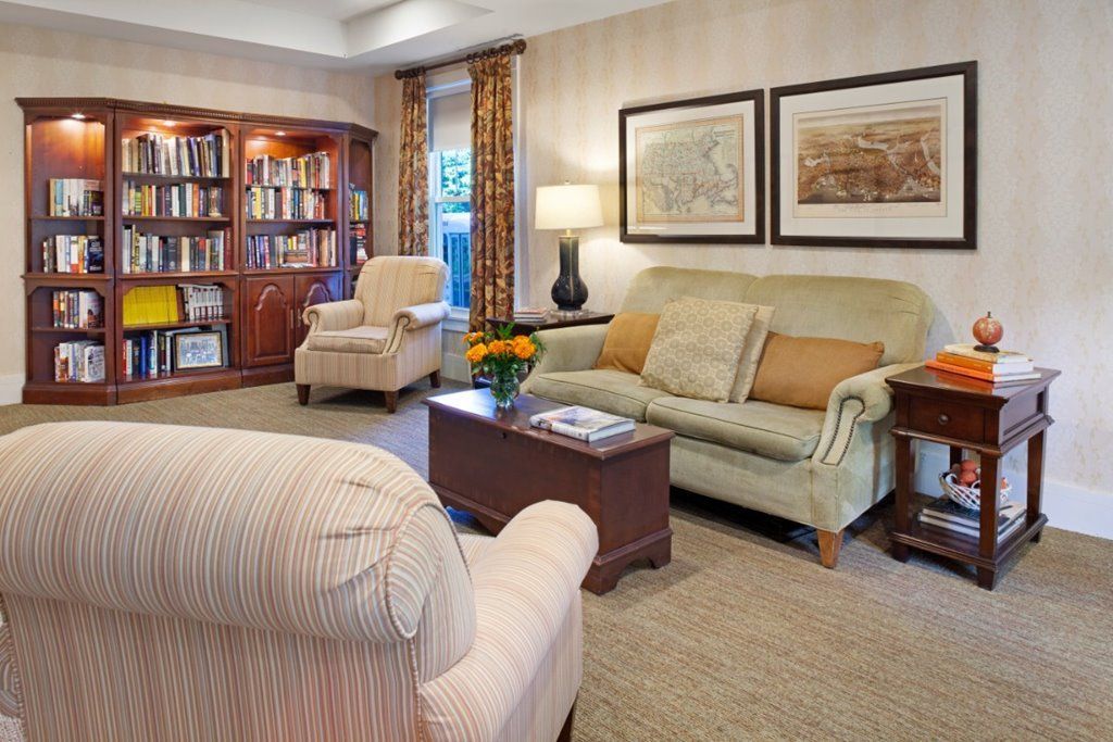 A cozy living room with comfortable seating and a well-stocked bookshelf.