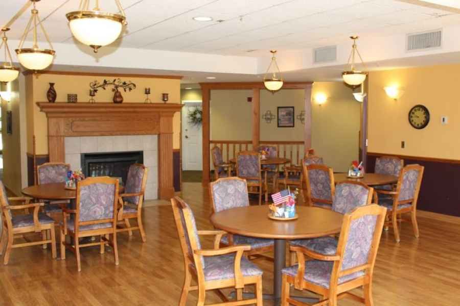 A cozy dining area with wooden furniture and a fireplace.