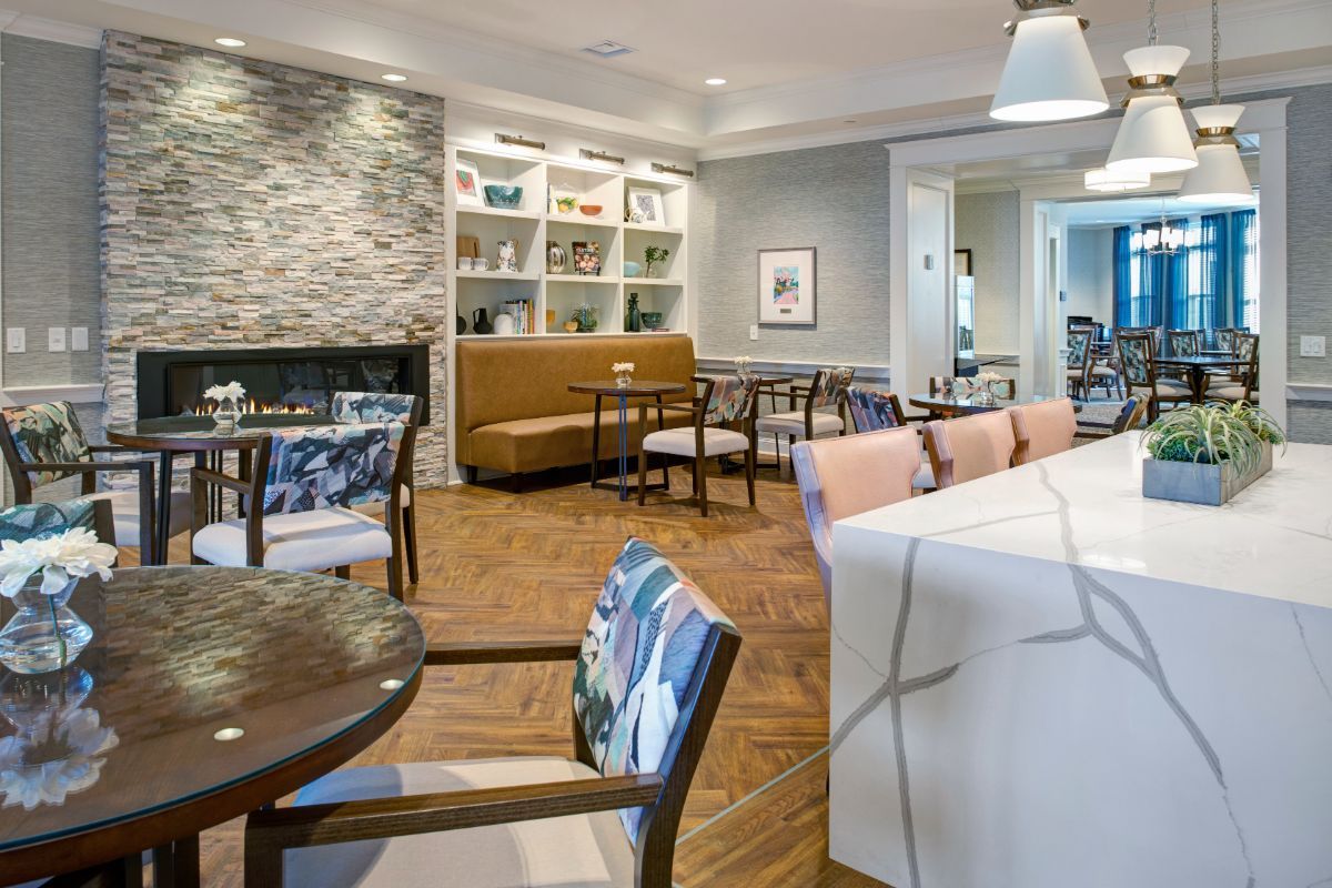 Elegant lounge area with modern furniture and a cozy fireplace.