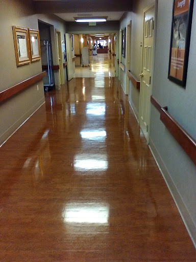 A well-lit hallway with polished floors and decorative walls.