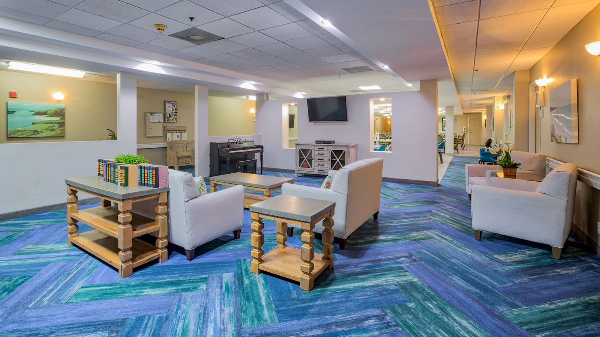 A modern lounge area with comfortable seating and a television.