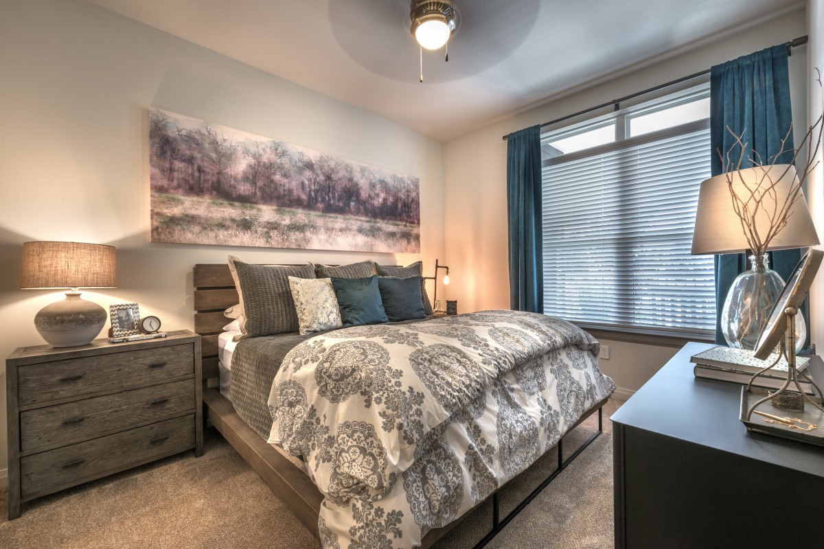 A modern bedroom with stylish furnishings and soft lighting.