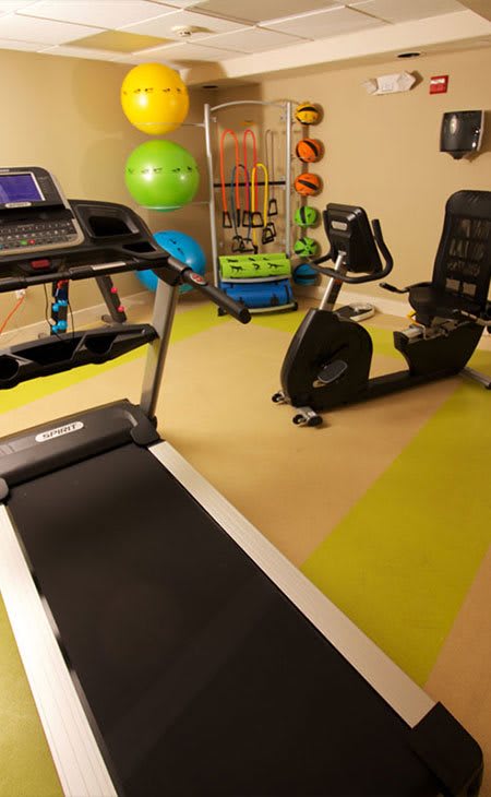 A home gym featuring a treadmill and a stationary bike for indoor workouts.