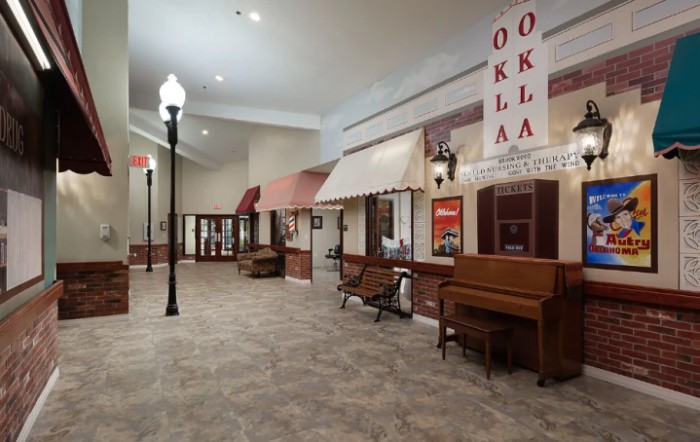 A vintage-style museum exhibit featuring storefronts, a piano, and street lamps.