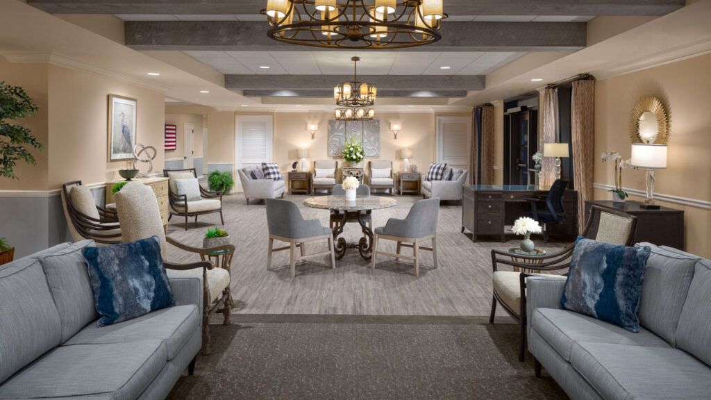 An elegantly designed living room with comfortable seating and chandeliers.