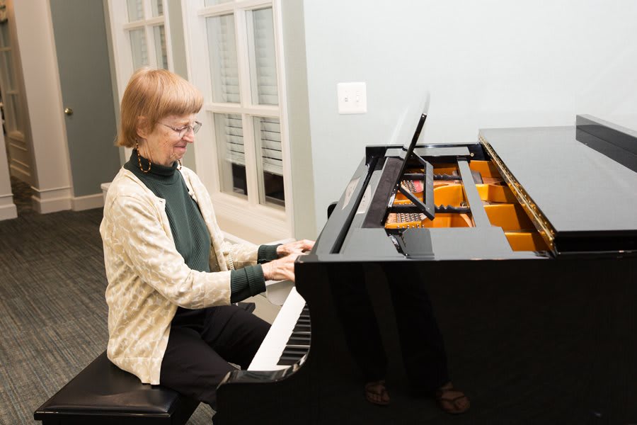 A woman playing the piano indoors.