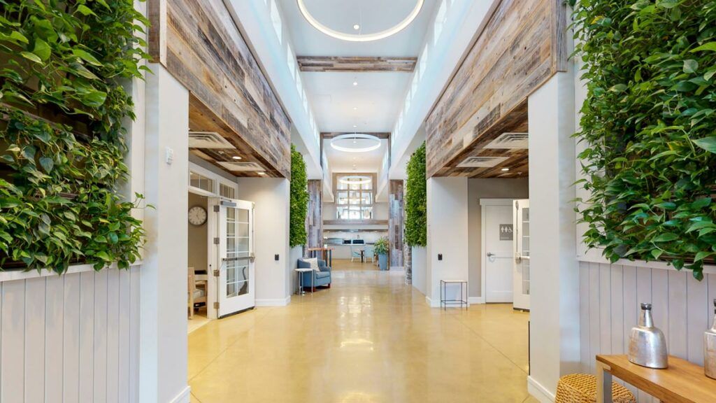 A spacious and modern hallway featuring wood accents and ample natural light.