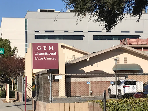 A view of the GEM Transitional Care Center, showcasing its distinct signage and architectural design.