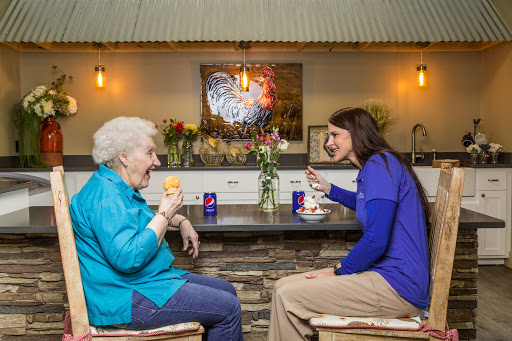 Two women enjoying a friendly conversation over drinks in a cozy caf setting.