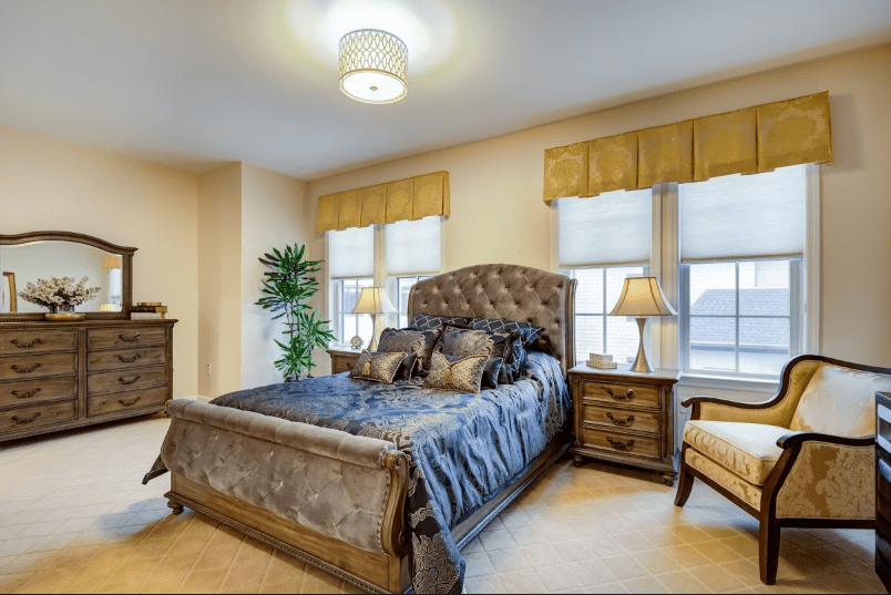 A cozy and elegant bedroom with a large bed, stylish furniture, and natural lighting.