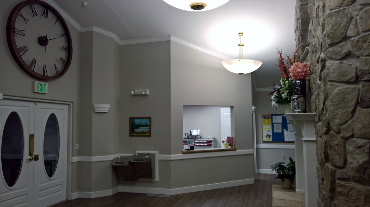 A well-lit reception area with an office desk and decor.