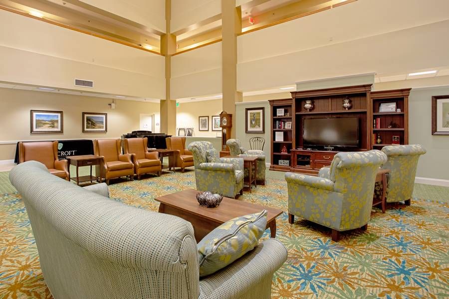 A spacious living room with comfortable seating and a large television.