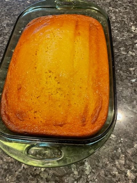 A freshly baked casserole in a glass dish on a kitchen countertop.