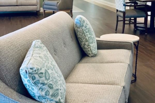 A cozy sofa adorned with patterned cushions in a living room setting.