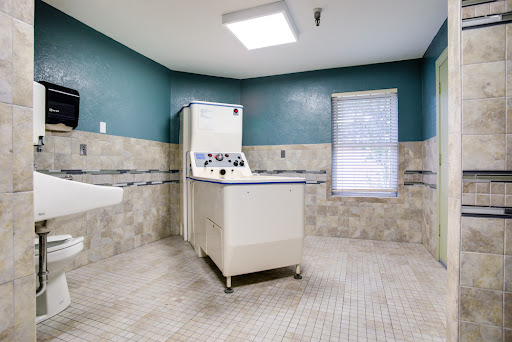 A spacious laundry room featuring a vintage washing machine and modern decor.