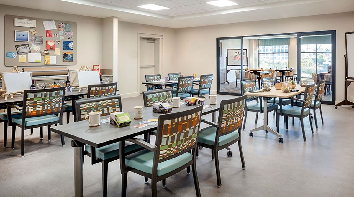 A modern, empty dining area with neatly arranged tables and chairs.