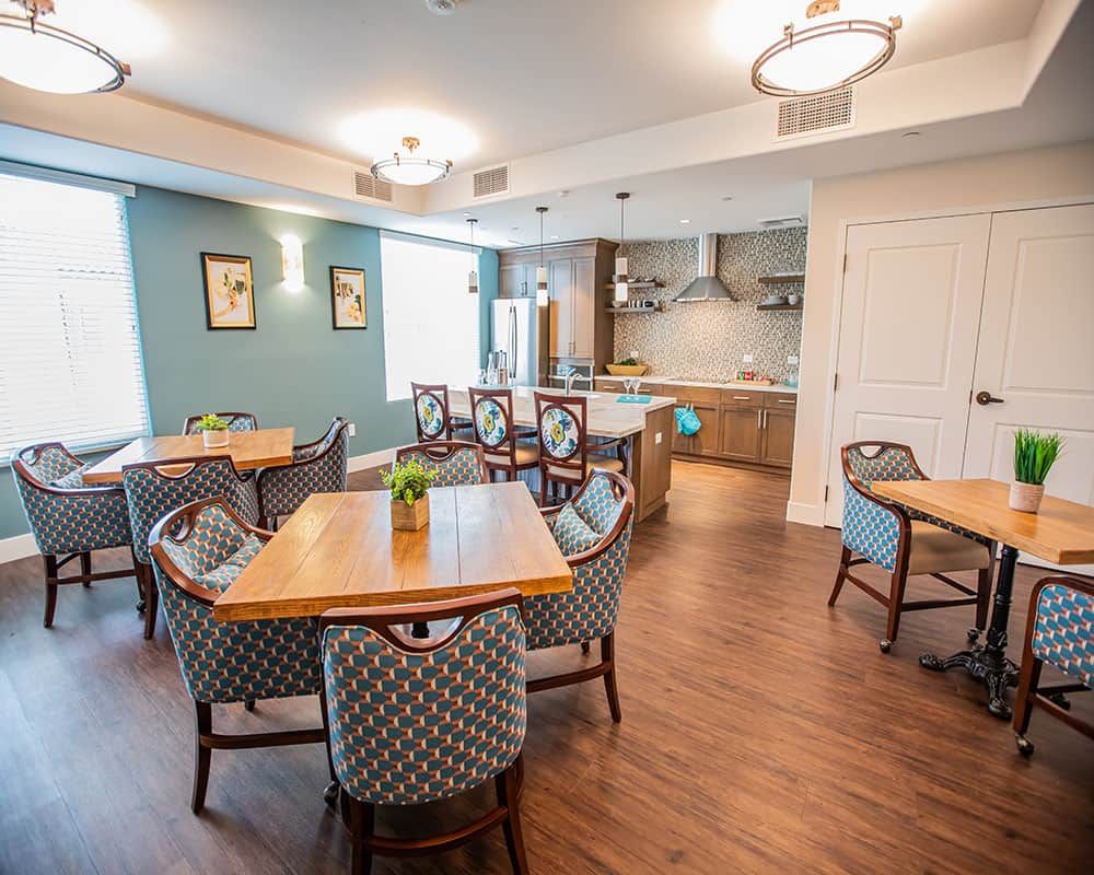 A modern kitchen and dining area with elegant furniture and bright lighting.