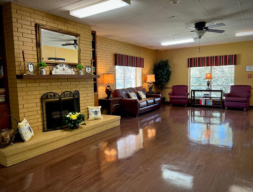 A cozy and inviting living room with a fireplace, comfortable seating, and warm lighting.