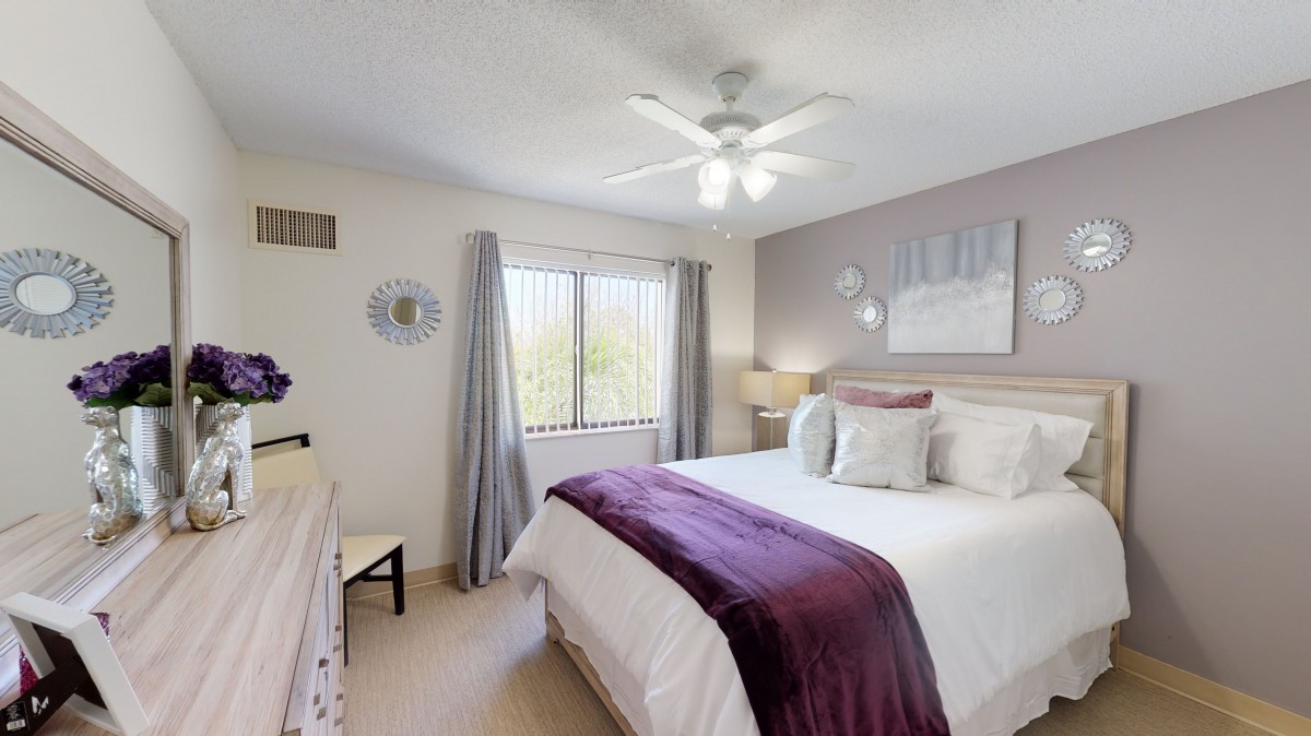 A cozy bedroom with a large bed, soft lighting, and elegant decor.