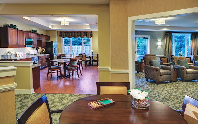 A cozy interior featuring a dining area, open kitchen, and a living room with comfortable seating.