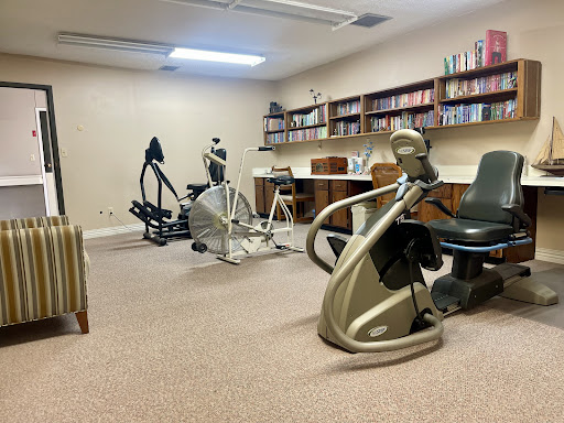 A well-equipped indoor fitness space featuring various exercise machines.