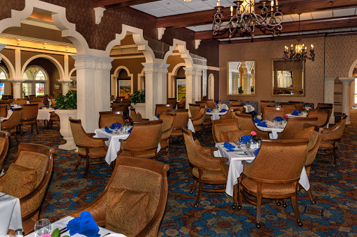 An elegant dining area featuring Arabian architectural elements, complete with stylish furniture and a blue and white color scheme.