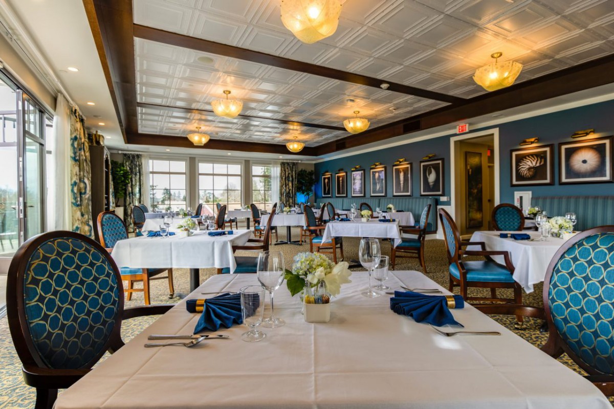 An elegant restaurant interior with neatly arranged tables and chairs.