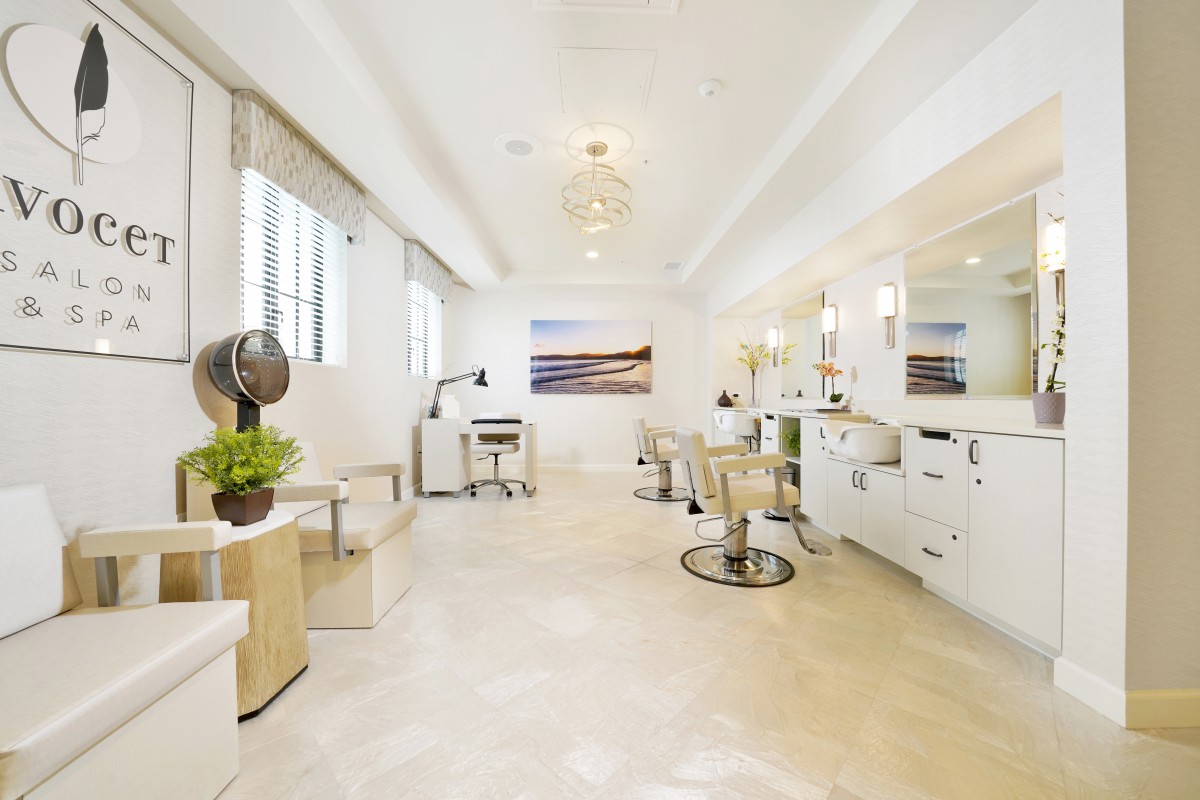 A bright and modern hair salon interior with stylish chairs and mirrors.