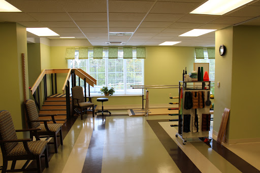 A spacious and well-lit physical therapy area equipped for rehabilitation exercises.